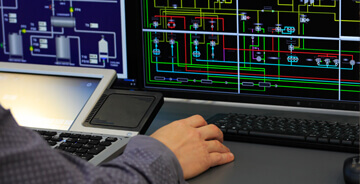 Engineer on a computer working on a building automation system